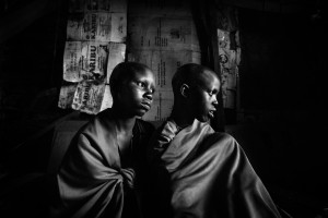 Masai girls Isina & Naserian are sitting in their father's hut the day before their planned circumcision.